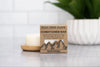 Rock Creek Soaps conditioner bar on a countertop with a blurred background