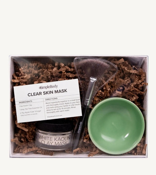 A photo of Simple ody's Clay Mask Kit which includes a recipe card, fan brush, Clay and bright green bowl packaged in a white gift box