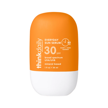 Orange and white sunscreen bottle with 'think daily' branding on a white background