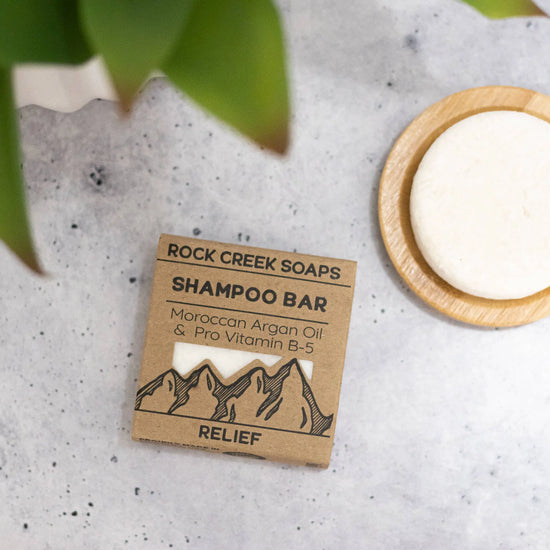 Rock Creek Soaps shampoo bar with packaging on a textured surface