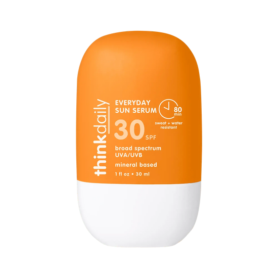 Orange and white sunscreen bottle with 'think daily' branding on a white background