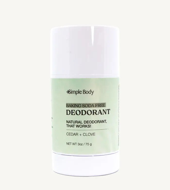 A white stick deodorant with minimal packaging, labeled 'Simple Body Baking Soda Free Deodorant' Cedar + Clove in a 3 oz tube.
