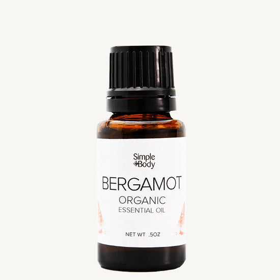Bottle of Simple Body Bergamot Organic Essential Oil on a white background