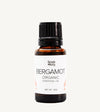 Bottle of Simple Body Bergamot Organic Essential Oil on a white background
