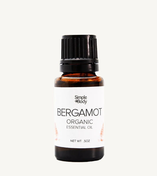 Bottle of Simple Body Bergamot Organic Essential Oil on a white background