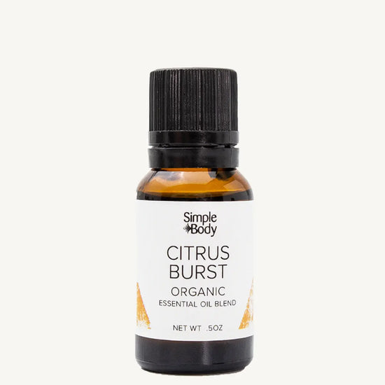 Bottle of Simple Body Citrus Burst organic essential oil blend on a white background
