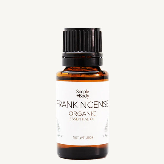 Bottle of Simple Body Frankincense Organic Essential Oil on a white background