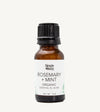 Brown glass bottle of Simple Body Rosemary + Mint organic essential oil blend on a white background