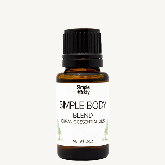 Bottle of Simple Body organic essential oils on a white background