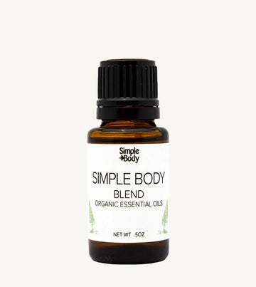 Bottle of Simple Body organic essential oils on a white background