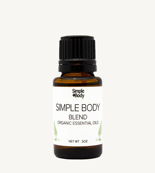 Bottle of Simple Body organic essential oils on a white background