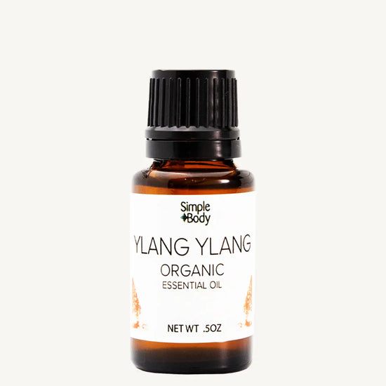 Bottle of Simple Body Ylang Ylang Organic Essential Oil on a white background