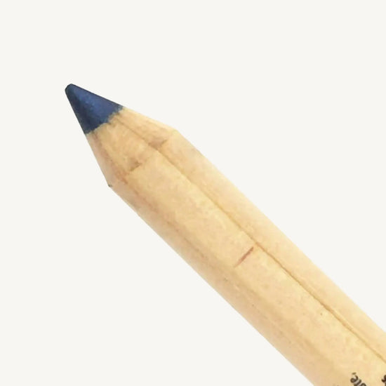 Pure Anada's Navy Eye Pencil close up on a beige background.