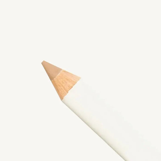 Makeup pencil with beige tan color on a white background