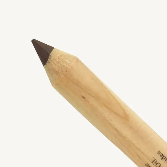 A closeup image of Pure Anada's Eyeliner pencil with brown tip on a white background