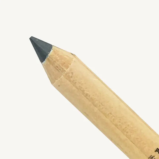 A closeup image of Pure Anada's Eyeliner pencil with a gray tip on a white background