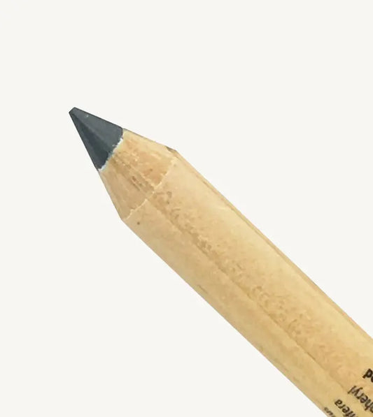 A closeup image of Pure Anada's Eyeliner pencil with a gray tip on a white background