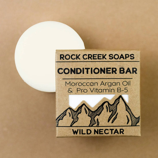 Rock Creek Soaps conditioner bar with packaging on a brown background