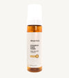An amber colored bottle of Simple Body Foaming Face Wash in chamomile, designed for sensitive skin.