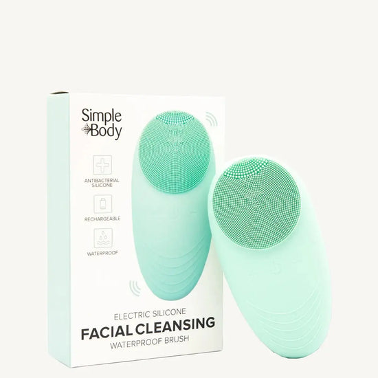 A facial cleansing brush with a silicone head, shown alongside its packaging which indicates it is waterproof and electric. The brand is Simple Body.