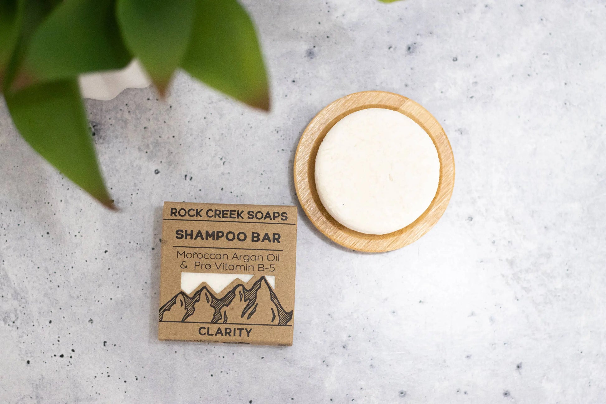 Rock Creek Soaps shampoo bar with packaging on a textured surface