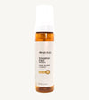 An amber colored bottle of Simple Body Foaming Face Wash in chamomile, designed for sensitive skin.