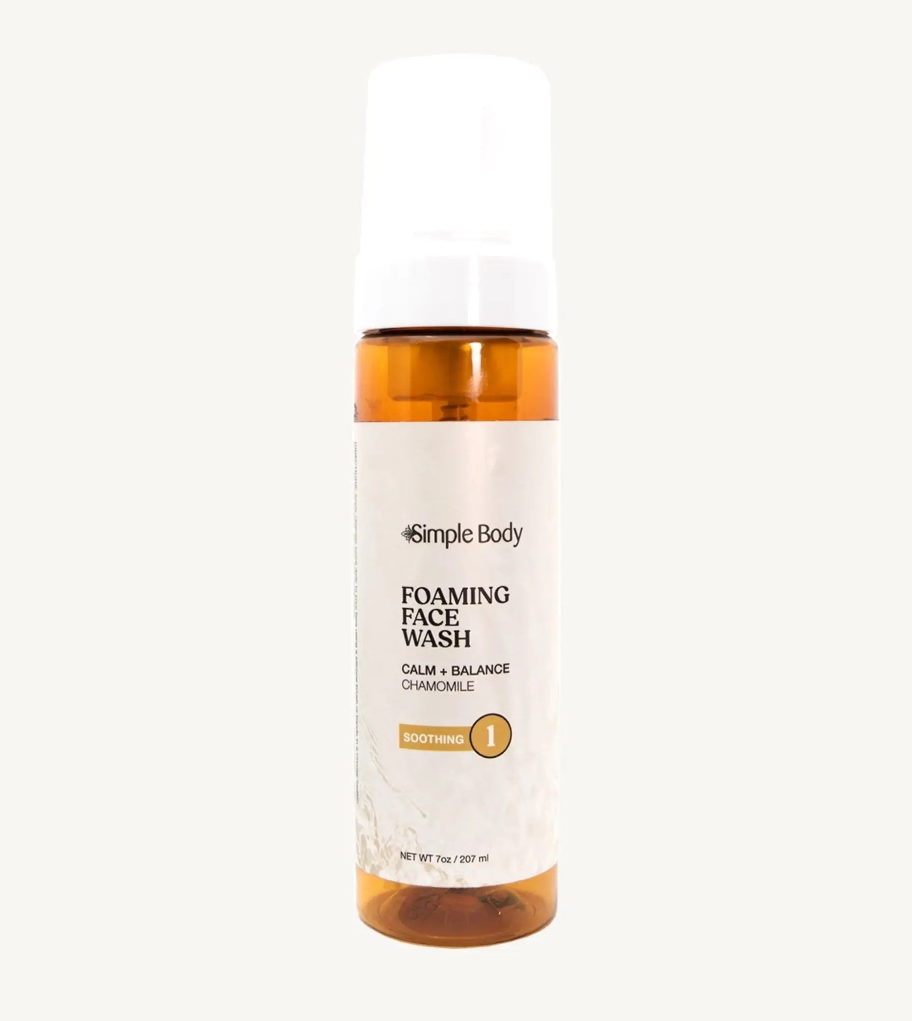 An amber colored bottle of Simple Body Foaming Face Wash in chamomile, designed for sensitive skin.