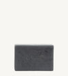 A handmade bar of soap with a gray color and an embossed design on it, placed against a white background.