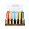 Thistle Farms Healing Collection essential oil roll-ons displayed on a wooden stand.