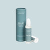 Thistle Farms Relief essential oil roll-on bottle and packaging on a light blue background