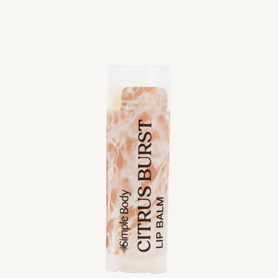 An oval lip balm tube with a label showing the product name, 'Citrus Burst Lip Balm', and the brand, 'Simple Body'. The background is off white.