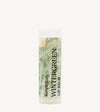 An oval tube of Simple Body Wintergreen Lip Balm with a green and white label, indicating it is nourishing lip care with a minty scent.