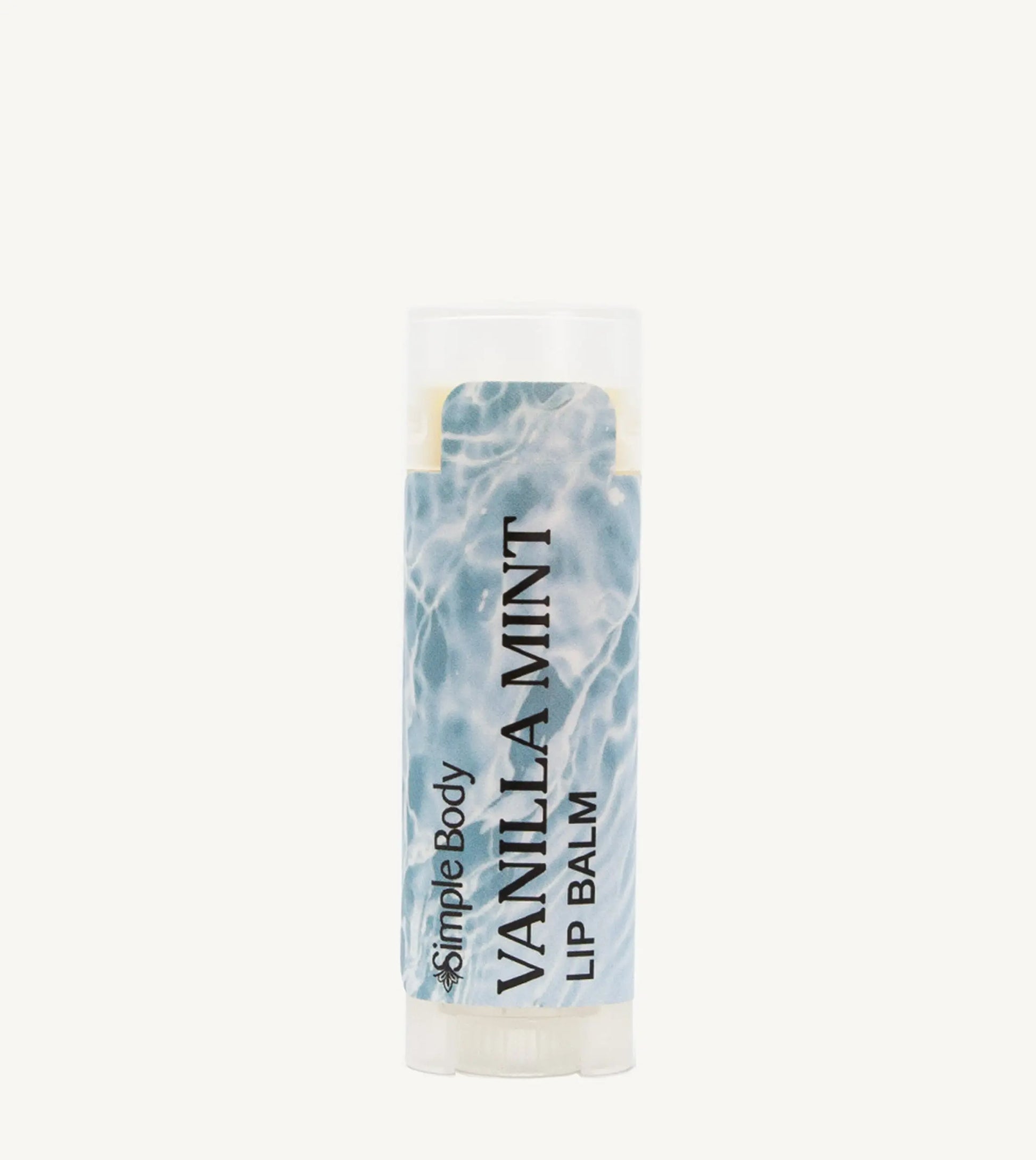 An oval lip balm tube with a label showing the scent 'Vanilla Mint' and a blue and white label.