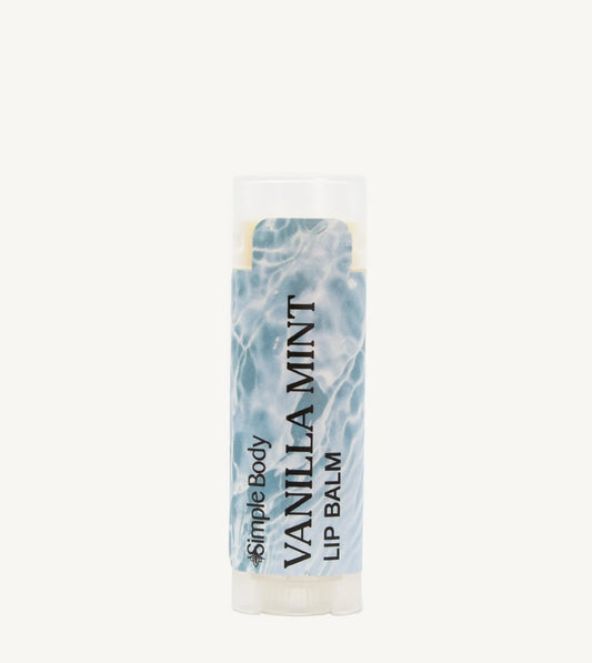 An oval lip balm tube with a label showing the scent 'Vanilla Mint' and a blue and white label.