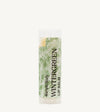 An oval tube of Simple Body Wintergreen Lip Balm with a green and white label, indicating it is nourishing lip care with a minty scent.