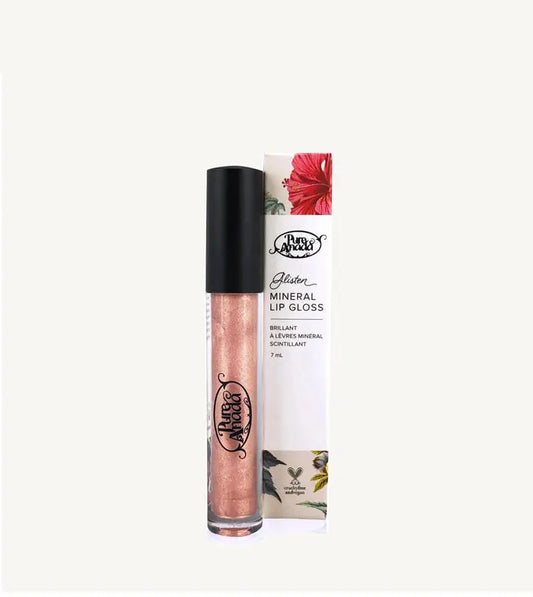 A photo of a tube of Pure Anada's Glisten Mineral Lip Gloss  with a shimmery peach color on a tan background.