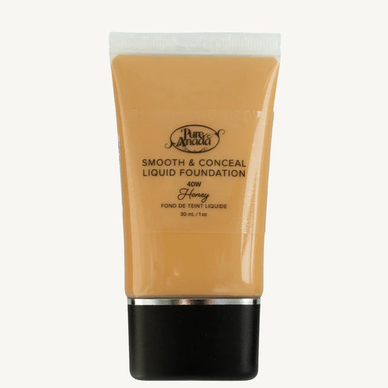 A bottle of Pure Anada Smooth & Conceal Liquid Foundation in Honey 40W which is a warm to darker beige with warm undertones on a white background.