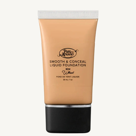 A close up photo of a liquid foundation in Wheat which is a warm beige honey color on a white background.