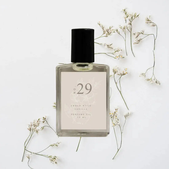 Perfume bottle labeled 'No. 29' with dried flowers on a light background