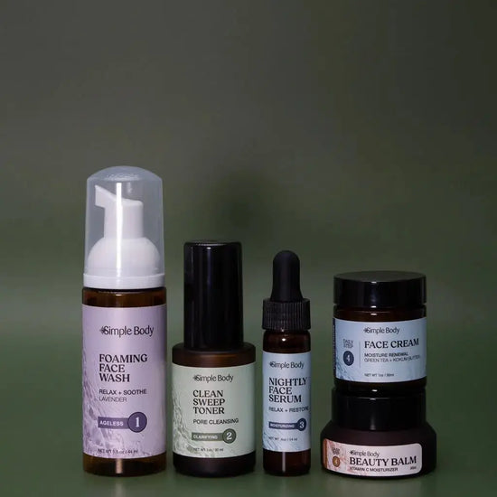A Mini Starter Skincare kit for acne prone skin including a Foaming Face Wash, Clean Sweep Toner, Nightly Face Serum, Face Cream, and Beauty Balm a dark green background.