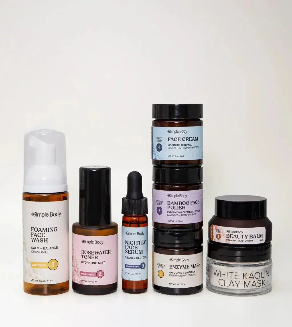 A Mini Starter Skincare kit for sensitive skin including a Foaming Face Wash, Rosewater Toner, Nightly Face Serum, Face Cream, Bamboo Face Polish, Enzyme Mask, Beauty Balm, and Clay Mask on a light tan background.