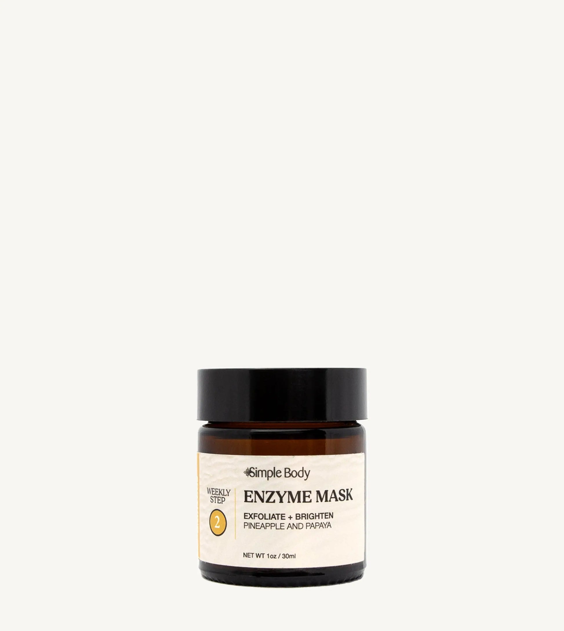 A jar of Simple Body Enzyme Mask, Papaya & Pineapple, designed for exfoliating and brightening the skin. The jar is recyclable glass with a black lid and a label that includes the product name and a brief description.