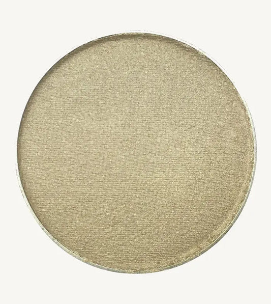A photo of Pure Anada's Pressed Eye Color in Mirage which is a silvery gray-green color on a tan background.