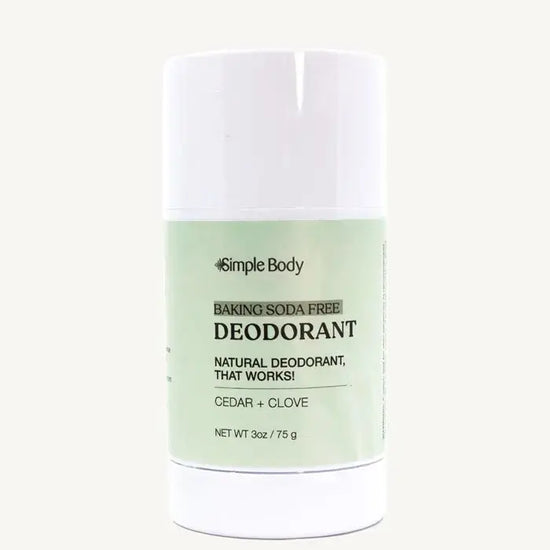 A white stick deodorant with minimal packaging, labeled 'Simple Body Baking Soda Free Deodorant' Cedar + Clove in a 3 oz tube.