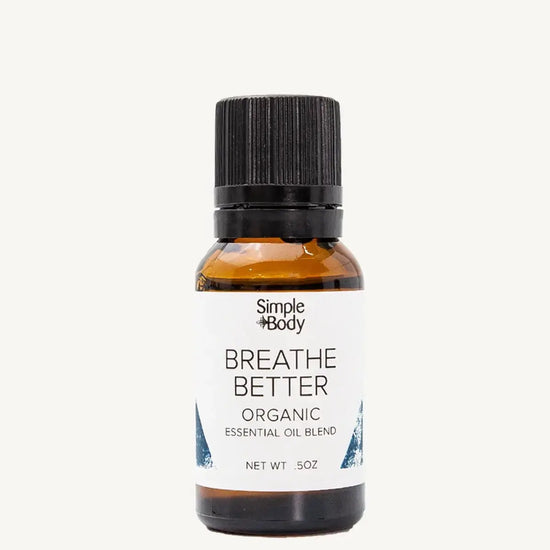 Bottle of Simple Body 'Breathe Better' organic essential oil blend on a white background