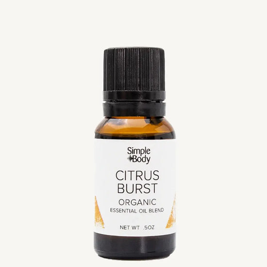 Bottle of Simple Body Citrus Burst organic essential oil blend on a white background