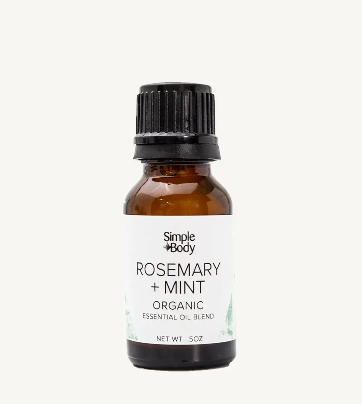 Brown glass bottle of Simple Body Rosemary + Mint organic essential oil blend on a white background