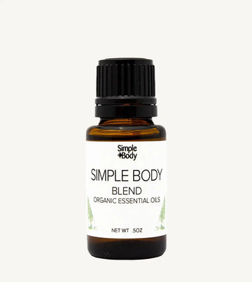 Bottle of Simple Body organic essential oils on a white background