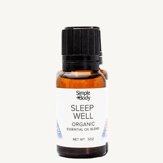 Bottle of Simple Body Sleep Well organic essential oil blend on a white background