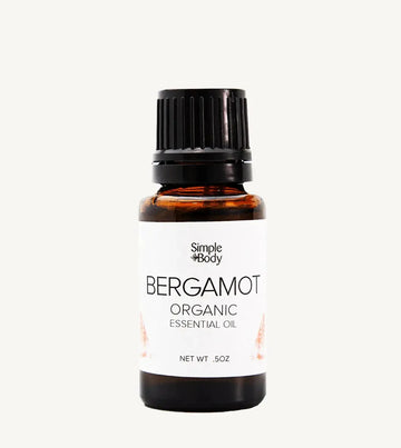 Bottle of Simple Body Bergamot Organic Essential Oil on a white background